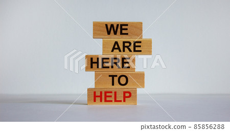 Wooden blocks with text 'we are here to help'. Beautiful white background, copy space. Business concept. 85856288