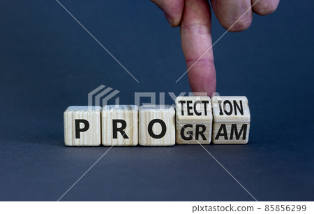 Protection program symbol. Businessman turns wooden cubes and changes the word 'program' to 'protection'. Beautiful grey table, grey background, copy space. Business, protection program concept. 85856299