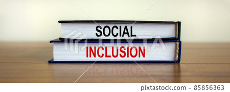 Books with text 'social inclusion' on beautiful wooden table. White background. Business concept. Copy space. Books with text 'social inclusion' on beautiful wooden table. White background. Business concept. Copy space. 85856363