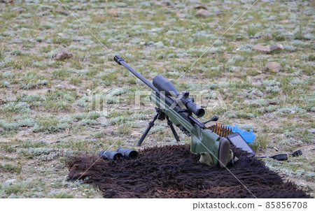 High-precision hunting rifle with an optical sight, cartridges and binoculars on the sighting. High-precision hunting rifle with an optical sight, cartridges and binoculars on the sighting. 85856708