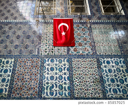 Istanbul, Turkey - November 2021: iznik tiles in Eyup Sultan mosque walls with a Turkish flag. Eyup Sultan Mosque is in the Eyup district of Istanbul, outside the city walls near Golden Horn. 85857025