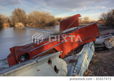 river irrigation dam and junk cars on a shore 85857473