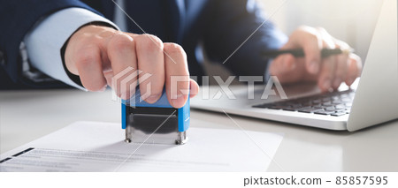 Businessman working in office with stamp 85857595