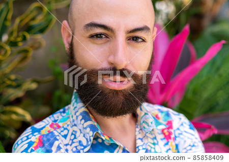 Smiling bearded man against tropical background 85858409