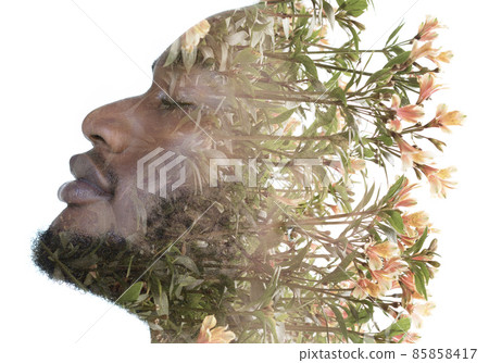 A portrait of a man dissolving into flowers in a double exposure technique. 85858417