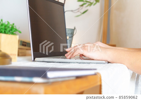 Young woman working on laptop at home.  85859062