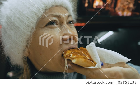 Girl eat pizza cheese four. Close up of young woman mouth greedily eating pizza and chewing in outdoor restaurant. Junk food. Pizza from open box. 85859135