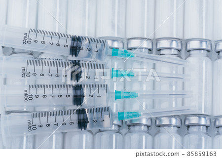 Medicine, Injection, vaccine and disposable syringe, drug concept. Sterile vial medical syringe needle. Glass medical ampoule vial for injection. Medicine, Injection, vaccine and disposable syringe, drug concept. Sterile vial medical syringe needle. Glass medical ampoule vial for injection. 85859163