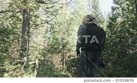 Traveler photographing scenic view in forest. One caucasian woman shooting nice magic look. Girl take photo video on dslr mirrorless camera. Traveler photographing scenic view in forest. One caucasian woman shooting nice magic look. Girl take photo video on dslr mirrorless camera. 85859659