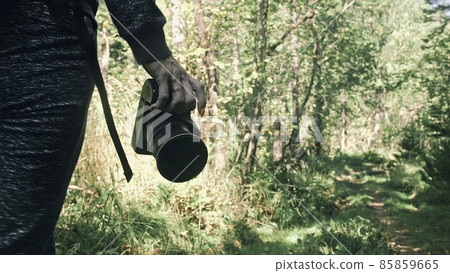 Traveler photographing scenic view in forest. One caucasian woman shooting close up look. Girl hold dslr mirrorless camera in his hand. Outdoor. Traveler photographing scenic view in forest. One caucasian woman shooting close up look. Girl hold dslr mirrorless camera in his hand. Outdoor. 85859665