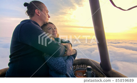 Adventure love couple on hot air balloon watermelon. Man and woman kiss hug love each other. Burner directing flame into envelope. Happy people. 85859689