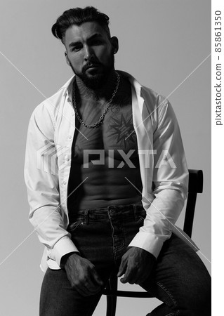 Muscular shirtless tattooed guy in studio 85861350