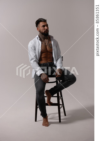 Muscular shirtless tattooed guy in studio Muscular shirtless tattooed guy in studio 85861351