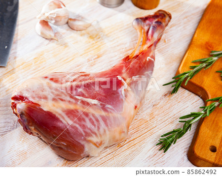 Raw young goat leg with rosemary and spices 85862492