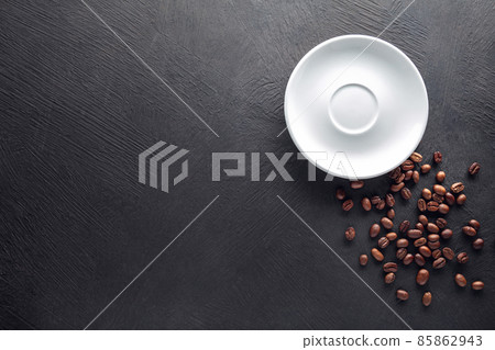 Saucer with beans on dark background Saucer with beans on dark background 85862943