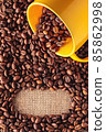 Coffee beans background with mug 85862998