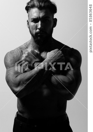 Muscular shirtless tattooed guy in studio 85863648