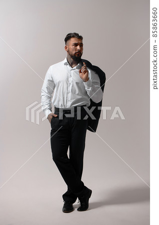 Man in elegant clothes on gray backdrop Man in elegant clothes on gray backdrop 85863660