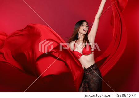 Young Slim Transgender Asian Woman wears red bikini bra dress, Beautiful Girl fluttering fabric 85864577