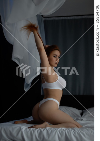 sexy lingerie babydoll Hot redhead woman in underwear on bed - Stock Photo [85864706]