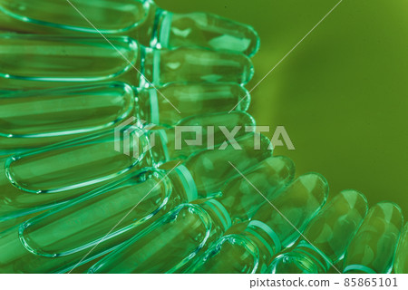 Glass medical ampoule vial for injection. Medicine is liquid sodium chloride with of aqueous solution in ampulla. Close up. Bottles ampule multicolor. 85865101