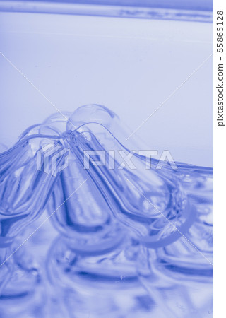 Glass medical ampoule vial for injection. Medicine is liquid sodium chloride with of aqueous solution in ampulla. Close up. Bottles ampule multicolor. Glass medical ampoule vial for injection. Medicine is liquid sodium chloride with of aqueous solution in ampulla. Close up. Bottles ampule multicolor. 85865128