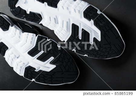 The black and white sole of trendy sports sneakers is a close-up in full screen. The black and white sole of trendy sports sneakers is a close-up in full screen. 85865199