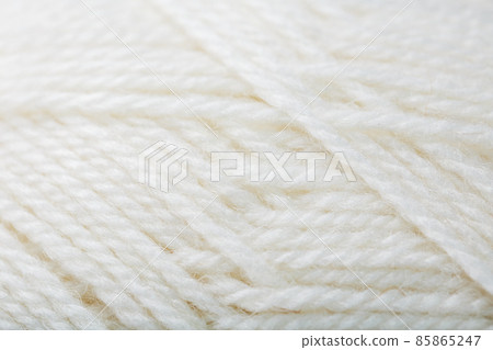 White wool yarn close-up in full screen 85865247
