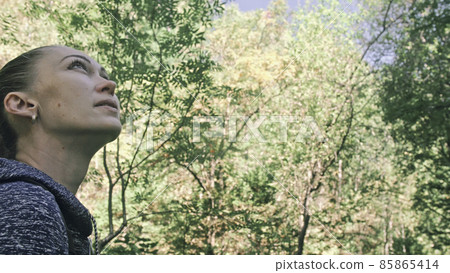 Traveler photographing scenic view in forest. One caucasian woman shooting nice magic look. Girl take photo video on dslr mirrorless camera. Traveler photographing scenic view in forest. One caucasian woman shooting nice magic look. Girl take photo video on dslr mirrorless camera. 85865414