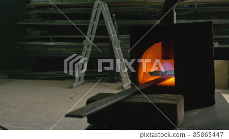 Forge workshop. Smithy manual production. Gas furnace for heating metal. Modern melting stove for iron steel. Blacksmith makes iron products. 85865447