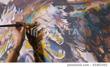 Artist designer draws an eagle on the wall. Craftsman decorator paints a picture with acrylic oil color brush. Close-up dark magic cinematic look. Artist designer draws an eagle on the wall. Craftsman decorator paints a picture with acrylic oil color brush. Close-up dark magic cinematic look. 85865493