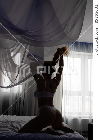 Hot redhead woman in underwear on bed 85865631