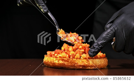 Craft burger is cooking on black background. Consist: sauce salsa, lettuce, red onion, pickle, cheese, chilli green pepper, bun, marbled meat beef. 85865632