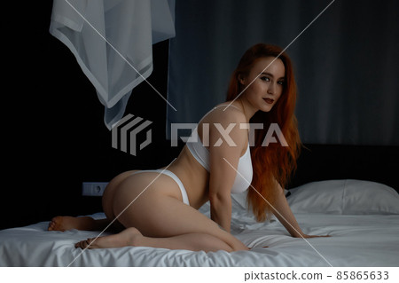 Hot redhead woman in underwear on bed 85865633