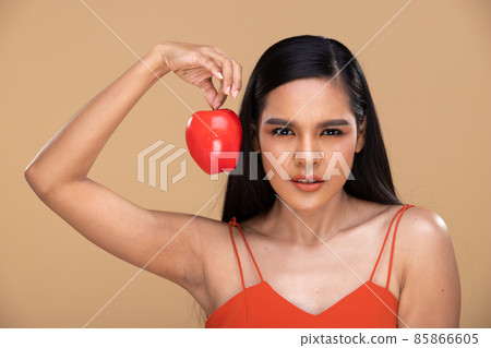 Asian Indian Woman hold apple fresh fruit with big teeth smile 85866605