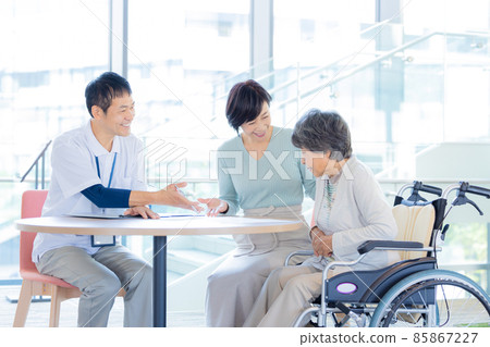 Facility staff explaining to parents and children of long-term care Photo cooperation "LINK FOREST] 85867227