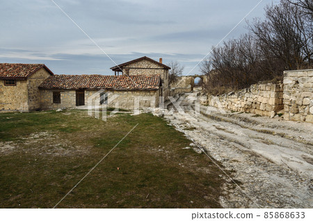 Homestead of A.S.Firkovich and the central defensive wall with Orta Kapu Gate in cave city Chufut-Kale in Bakhchysarai, Crimea Homestead of A.S.Firkovich and the central defensive wall with Orta Kapu Gate in cave city Chufut-Kale in Bakhchysarai, Crimea 85868633