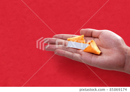 Fortune cookies with an empty quote on a human hand with a colored background 85869174
