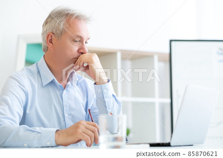 Overworked man. Work depression. Business bankruptcy. Tired unhappy middle age male employee working at laptop office desk workplace. Overworked man. Work depression. Business bankruptcy. Tired unhappy middle age male employee working at laptop office desk workplace. 85870621