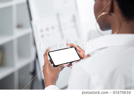Mobile app. Gadget leisure. Phone advertisement. Touchscreen template. Unrecognizable woman using cell white copy space screen mockup indoors. Mobile app. Gadget leisure. Phone advertisement. Touchscreen template. Unrecognizable woman using cell white copy space screen mockup indoors. 85870638