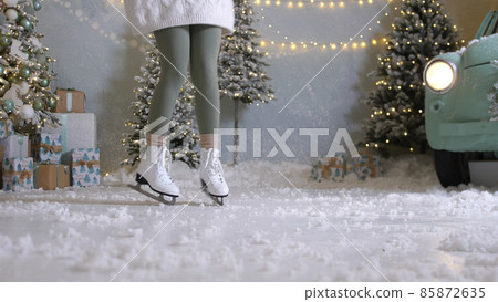 Happy young woman skates on ice rink 85872635