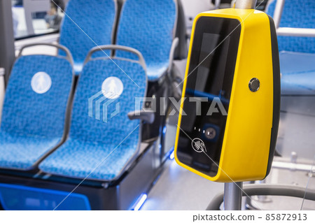 comfortable city bus, an electric bus or a hydrogen bus cabin with payment for travel via validator 85872913