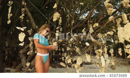 Pretty woman walking alone on beach and relax among the tree hun 85873089