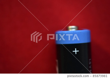 AA finger battery on a red background AA finger battery on a red background 85873981