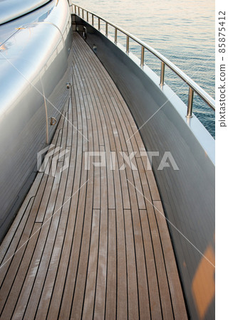 Beautiful sea view from the starboard side of a luxury yacht at sunset / sunrise - vertical orientation, high angle view Beautiful sea view from the starboard side of a luxury yacht at sunset / sunrise - vertical orientation, high angle view 85875412