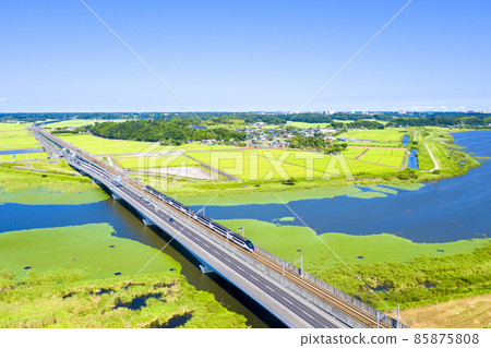 A photo shoot of Keisei Skyliner and National Route 464 crossing Inba-numa in Chiba Prefecture 85875808