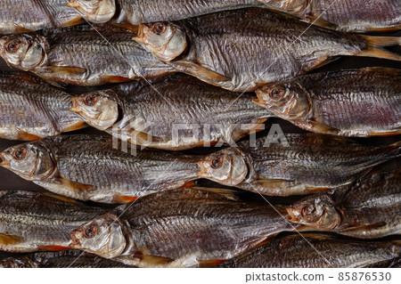 Lots of dried or jerky salted taranka. Fishes background. Salty beer appetizer. Traditional way of preserving fish. Close up 85876530