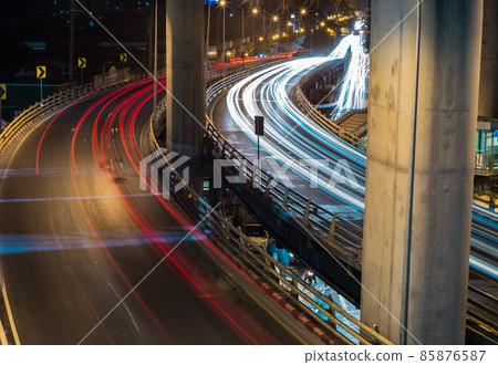 Overpass of the light trails with Bangkok city background at night. Overpass of the light trails with Bangkok city background at night. 85876587