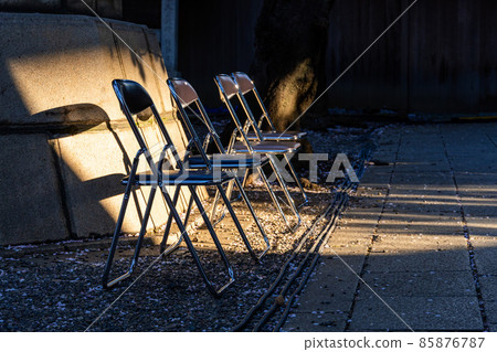 Folding chair and cherry blossom petals 85876787