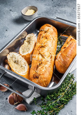 Garlic butter baguette, baked bread with herbs and thyme. Gray background. Top view. Copy space 85877857